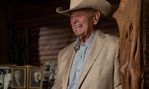 man with a suit and cowboy hat